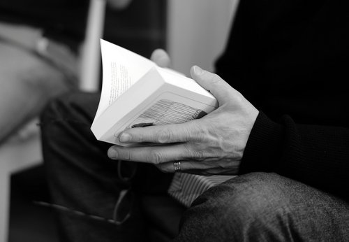 Mann hält Buch in der Hand