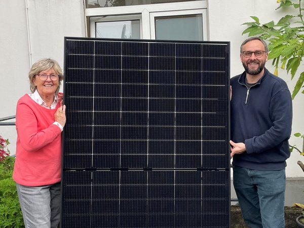 Frau und Mann mit einem Solarmodul