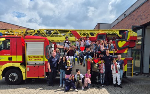 Kindergruppe vor einem Feuerwehrauto