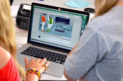 Zwei Personen vor einem Laptop