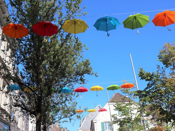 Bunte Regenschirme hängen an einer Leine 