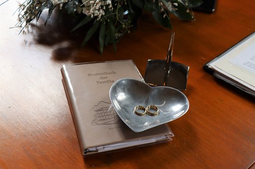 Familienstammbuch, Ringe und Blumen auf einem Tisch