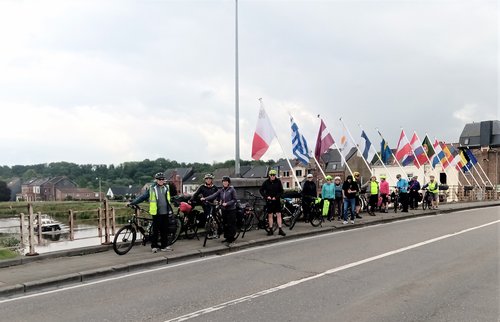 Radfahrer auf einer Brücke mit verschiedenen Länderfahnen